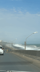 Driver records coastal highway view in La Perla, Peru