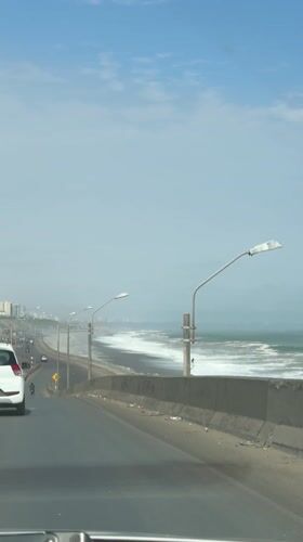 Driver records coastal highway view in La Perla, Peru