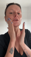 Woman applies makeup in Tunbridge Wells bathroom