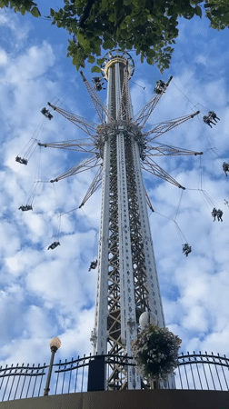 Swing ride spinning in Stockholm on a cloudy summer afternoon