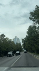 Dashcam-style drive through Almaty traffic with bus in view