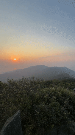 Sunset captured over foggy Đà Nẵng cityscape and mountains