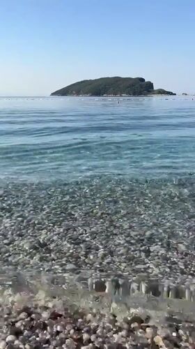 Calm morning on a pebble beach in Budva, Montenegro
