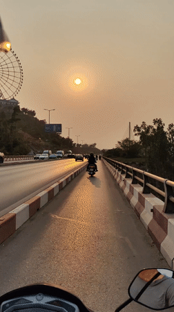 Motorcycle riders travel through Hong Gai Ward streets