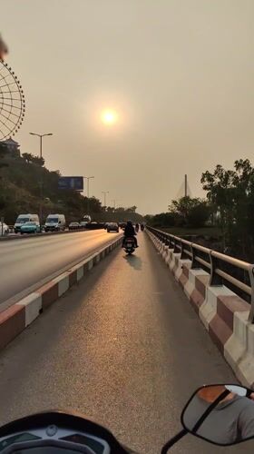 Motorcycle riders travel through Hong Gai Ward streets