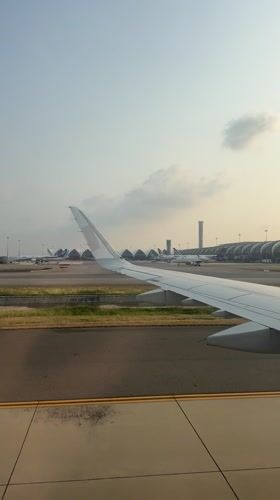 Passenger films airport view from plane window in Thailand