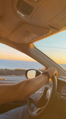 Driver enjoys ocean sunset view during Malibu coastal drive