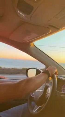 Driver enjoys ocean sunset view during Malibu coastal drive