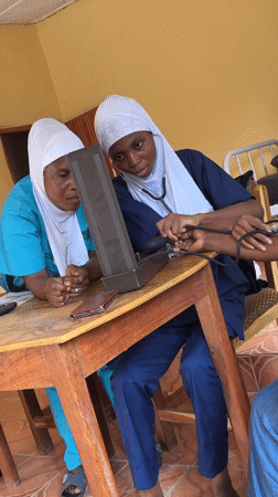 Healthcare workers conduct blood pressure checks in Madangala clinic