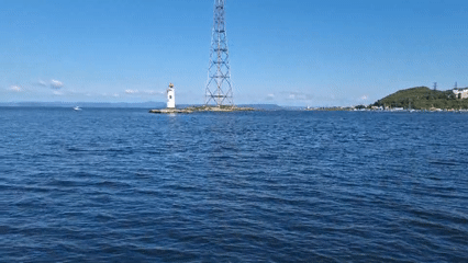 Lighthouse and metal tower on rocky island off Vladivostok