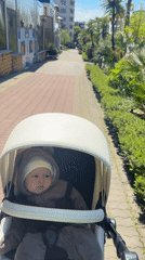 Mother and baby in bear costume enjoy sunny stroll in Sochi