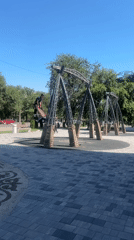 Industrial swing set and gabion wall in an Almaty public space