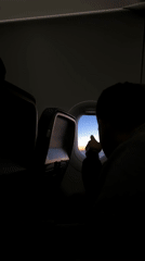 Passenger documents sunrise view from airplane window over Germany
