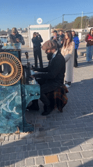 Street musician performs on decorated piano in Odesa square