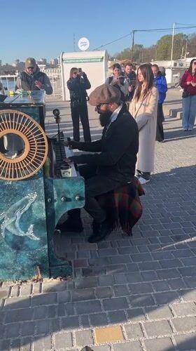Street musician performs on decorated piano in Odesa square