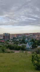 Tourist documents Kokshetau cityscape and monuments from hilltop vantage