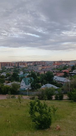 Tourist documents Kokshetau cityscape and monuments from hilltop vantage