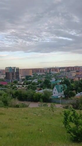 Tourist documents Kokshetau cityscape and monuments from hilltop vantage