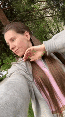 Woman takes selfies on street in Klin, Russia