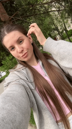 Woman takes selfies on street in Klin, Russia