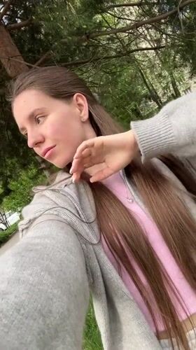 Woman takes selfies on street in Klin, Russia