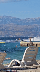Sunny afternoon on a pebble beach in Supetar, Croatia