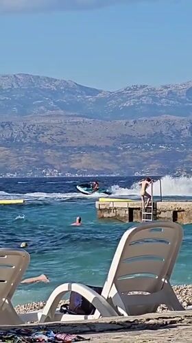 Sunny afternoon on a pebble beach in Supetar, Croatia