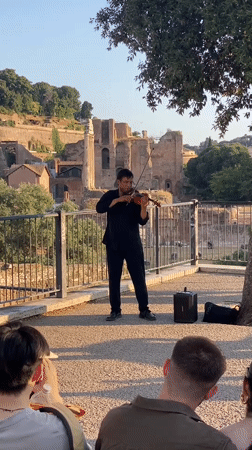 Violinist performs for street crowd in central Rome