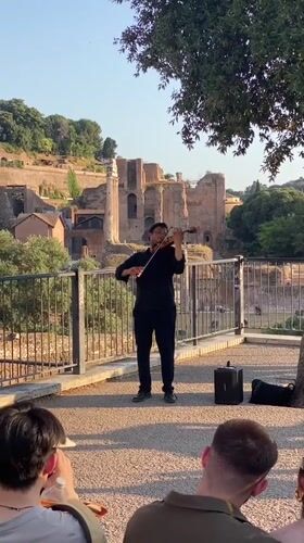 Violinist performs for street crowd in central Rome