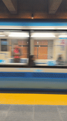 Subway train passes through Laval station platform