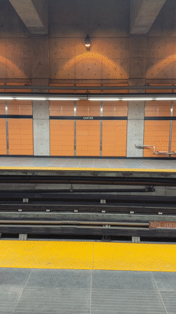 Subway train passes through Laval station platform