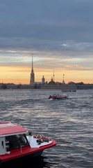 Boats navigate waterway near fortress in Saint Petersburg