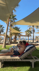 Sunny resort afternoon — pool, loungers, and a glass of wine