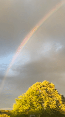 Rainbow appears over rural Zelenikovo, Bulgaria amid storm clouds
