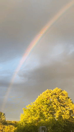 Rainbow appears over rural Zelenikovo, Bulgaria amid storm clouds