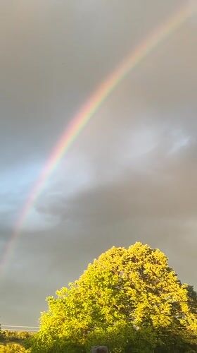 Rainbow appears over rural Zelenikovo, Bulgaria amid storm clouds