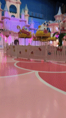 Visitor documents pink-themed children's park area in Moscow