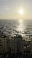 Beachfront residential buildings captured in Bat Yam during golden hour
