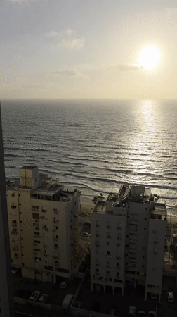 Beachfront residential buildings captured in Bat Yam during golden hour