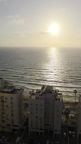 Beachfront residential buildings captured in Bat Yam during golden hour