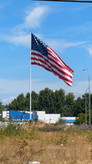 American flag flies high over a building in Fife, Washington