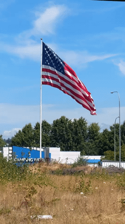 American flag flies high over a building in Fife, Washington