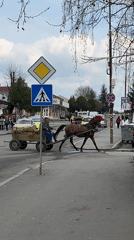 Horse-drawn hay cart travels through Yambol street