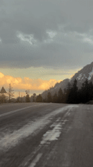 Vehicle travels wet road under overcast skies in Akseki