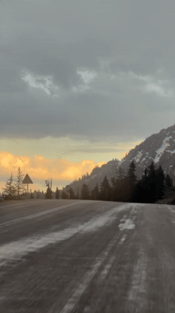 Vehicle travels wet road under overcast skies in Akseki