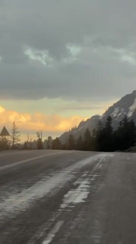 Vehicle travels wet road under overcast skies in Akseki