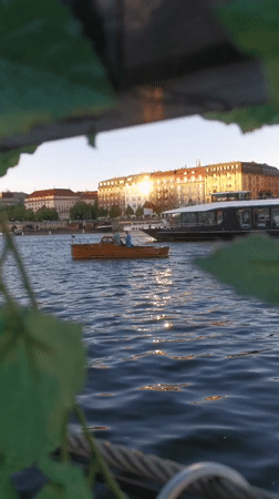 Artist displays nun dolls along Prague riverfront during evening hours