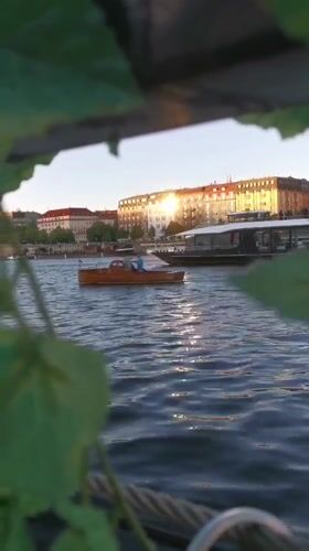 Artist displays nun dolls along Prague riverfront during evening hours