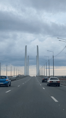 Driving across Cherepovets' cable-stayed bridge on an overcast day