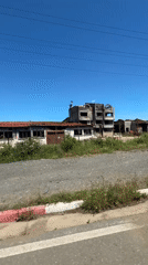Abandoned building complex observed from vehicle in Sredets, Bulgaria